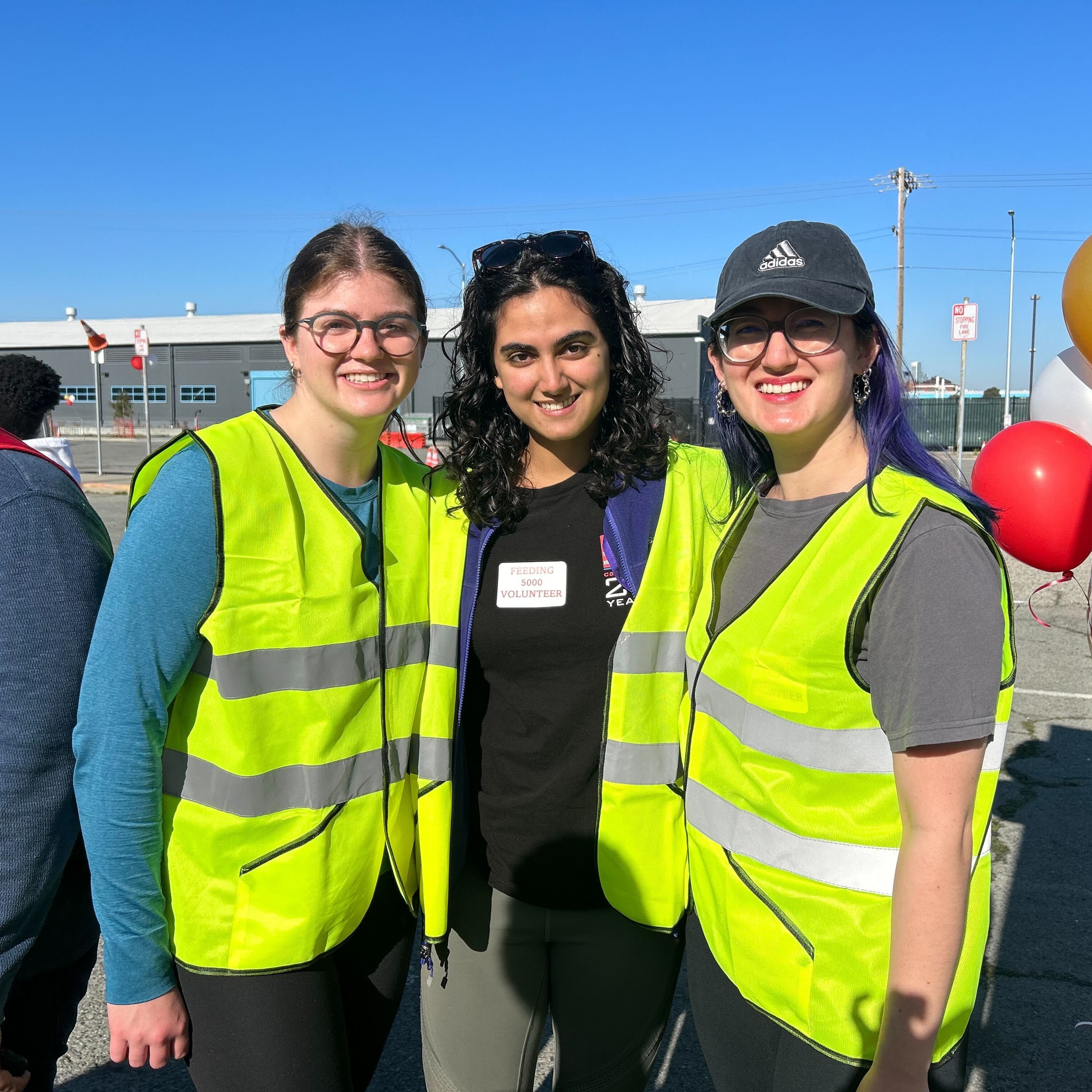 Alya is standing in the middle of the frame facing the camera. To the left is AmeriCorps member Emily Whalen and to the right is AmeriCorps member Megan Armstrong. 