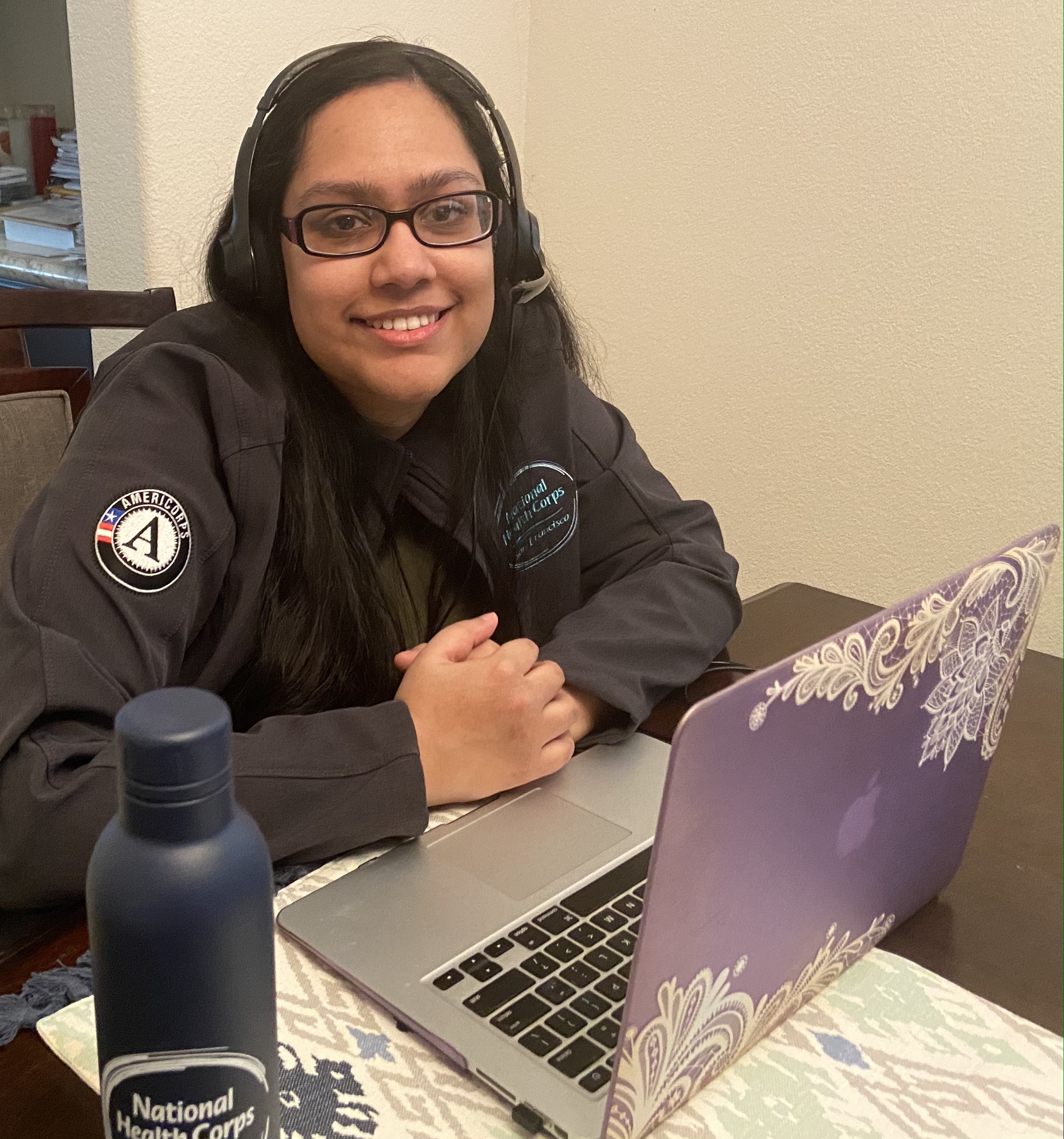 Tahemina Munir sittiing in front of her laptop as she serves from home.