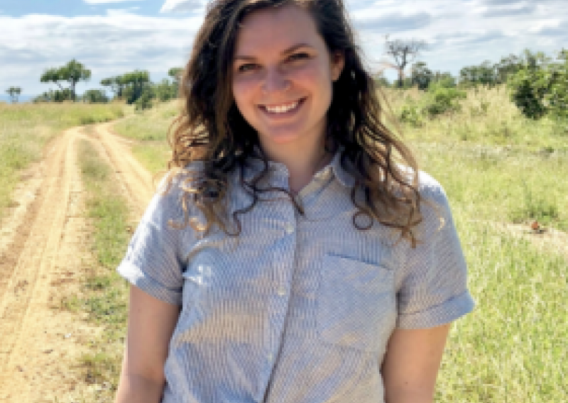 NHC PGH member Emily smiling on a sunny day in the countryside 