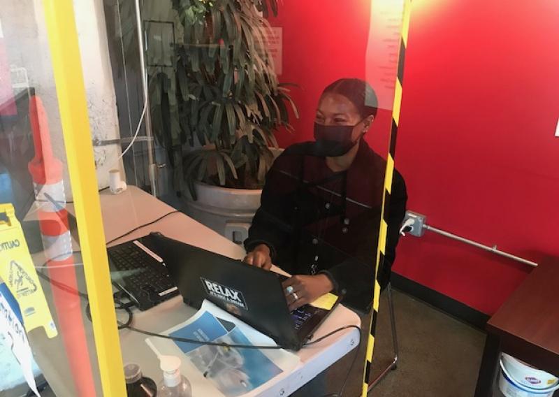 Brianna Bingham sitting in front of a computer during her service. 