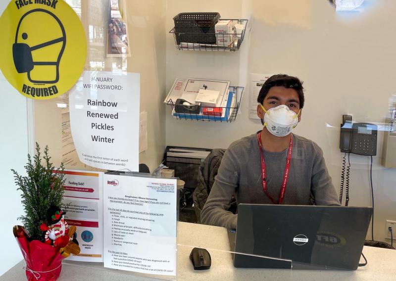 Johnny is seen behind his service station at HealthRIGHT 360, waiting to assist patients that walk into the clinic for services.