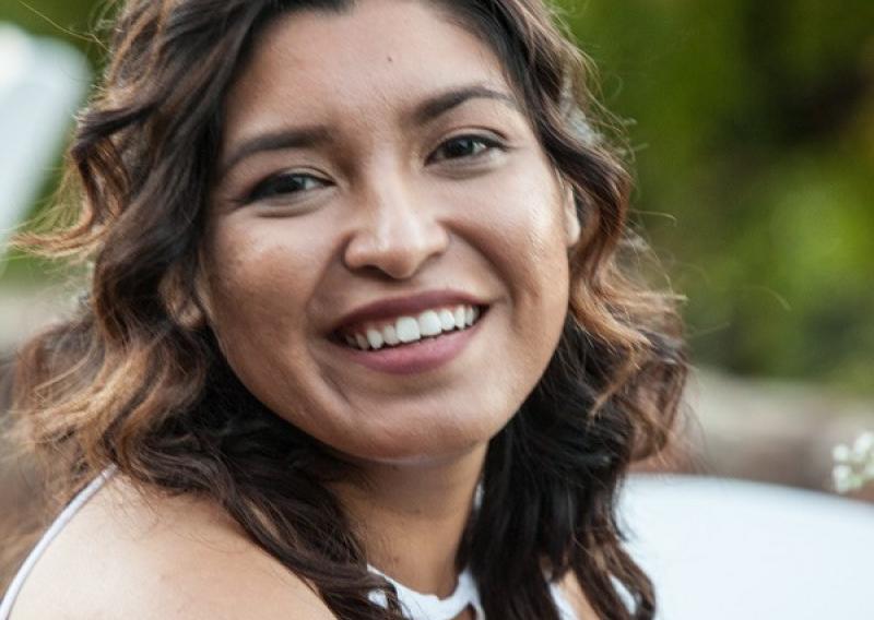 Maria Hower is seen facing the camera and smiling. 