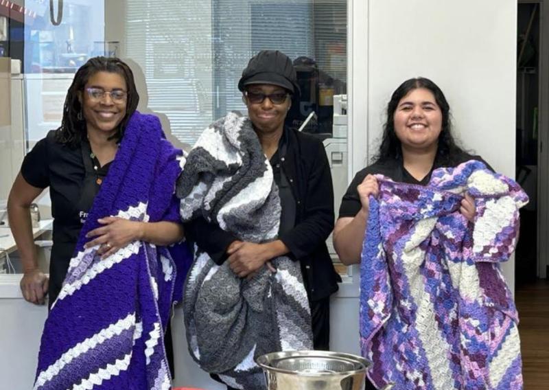 Supervisor Dr. Neva White, Project Manager Johnetta Frazier, and Ann Sunny receiving blankets after Lunch & Learn Workshop.