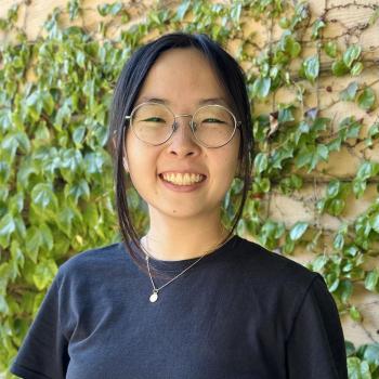 Tammy is facing the camera from the center of the frame, and smiling. 