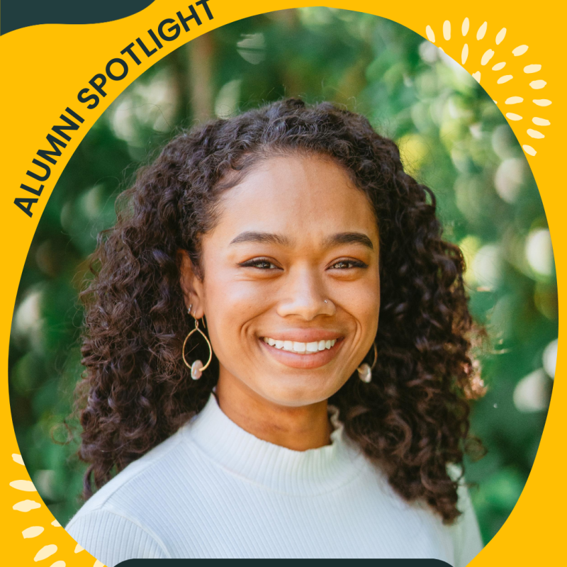 The image is an edited Canva image title Alumni Spotlight. In the middle is a headshot of Whitney Francis smiling at the camera. Below is a caption stating "Whitney Francis, NHC SF 2019-2020". 