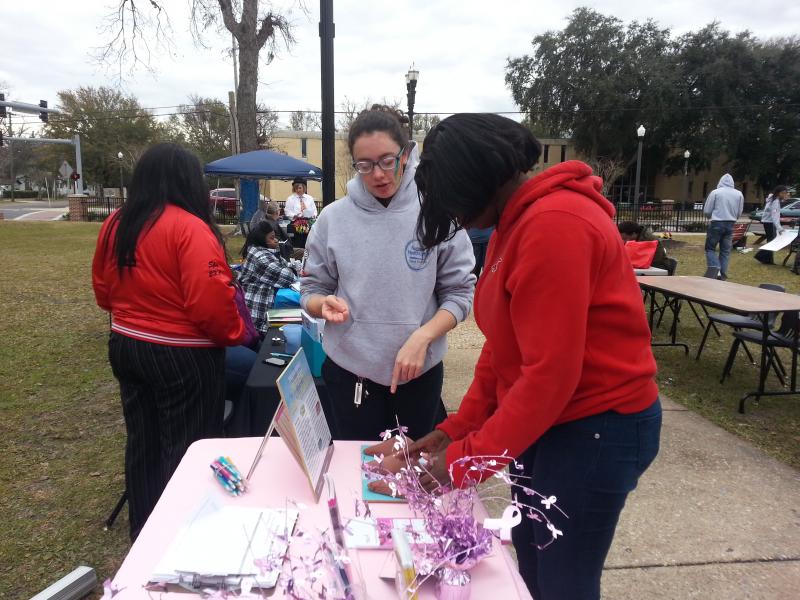 NFHC AmeriCorps member, Rachel, demonstrating breast self exams