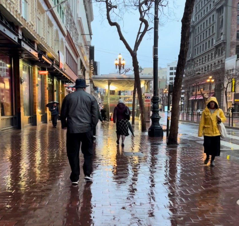 A wet sidewalk early in the morning. 